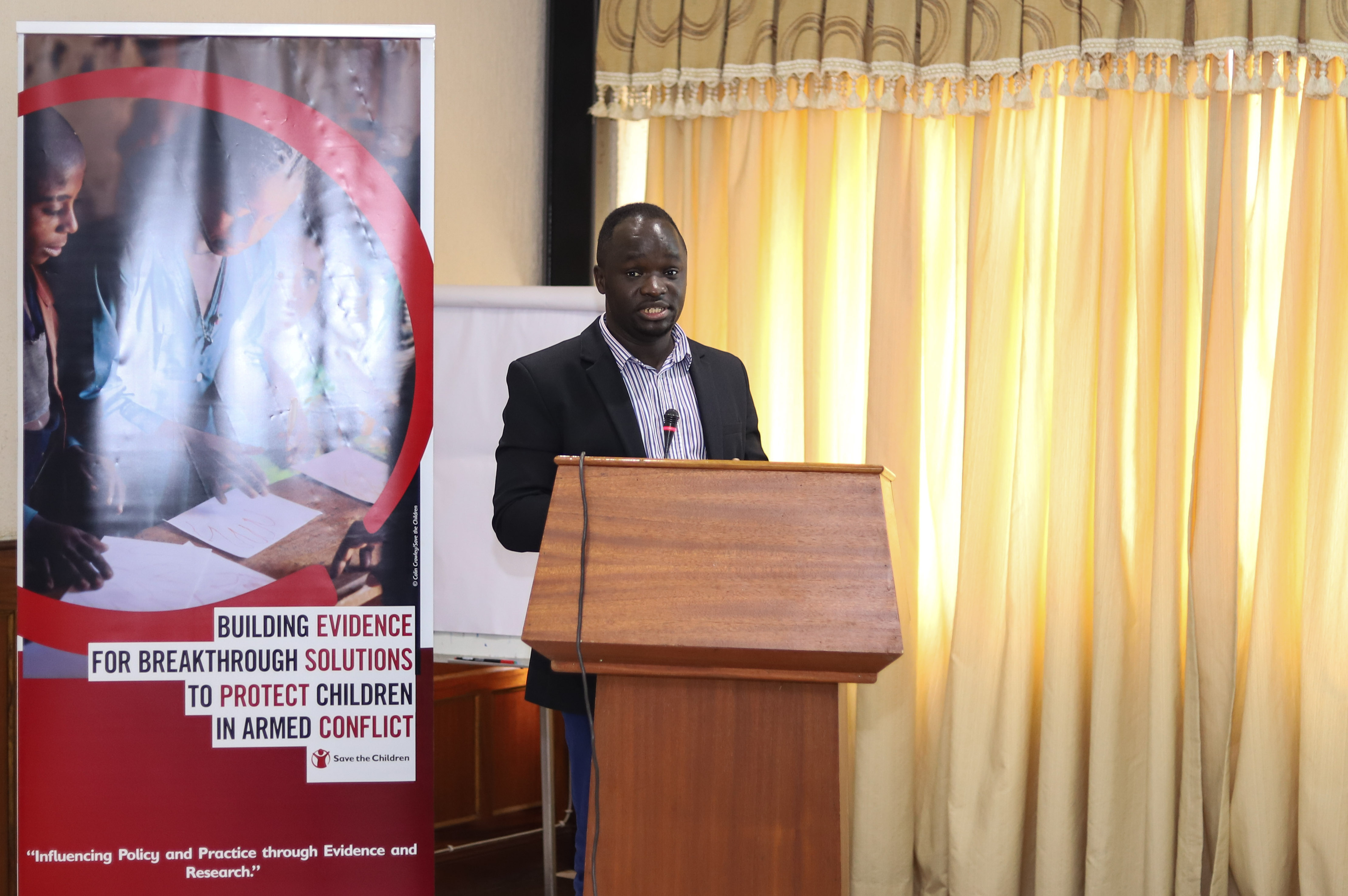 Dr Robert Nanima presenting a paper at the Knowledge Exchange organised by Save the Children in Uganda.