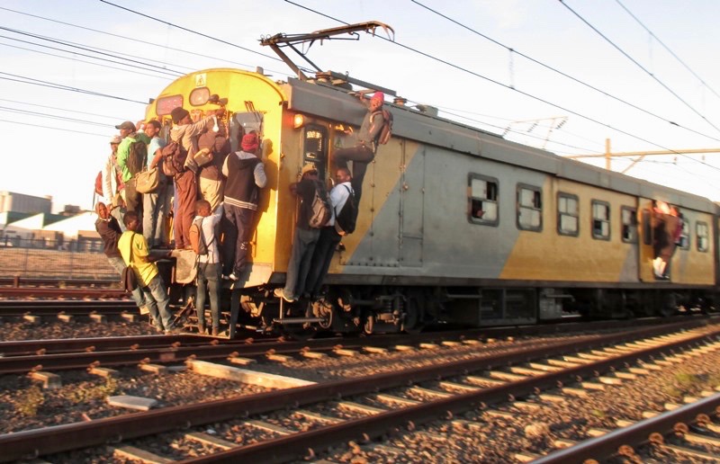 Overcrowding on trains calls for desperate measures by commuters dependent on train services.  PHOTO: Mandla Mnyakama/GroundUp